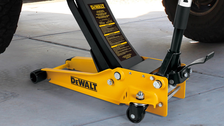 A DeWalt 3-Ton Steel Service Jack lifting up a vehicle