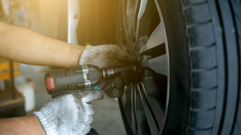 Closeup of a mechanic changing a tire