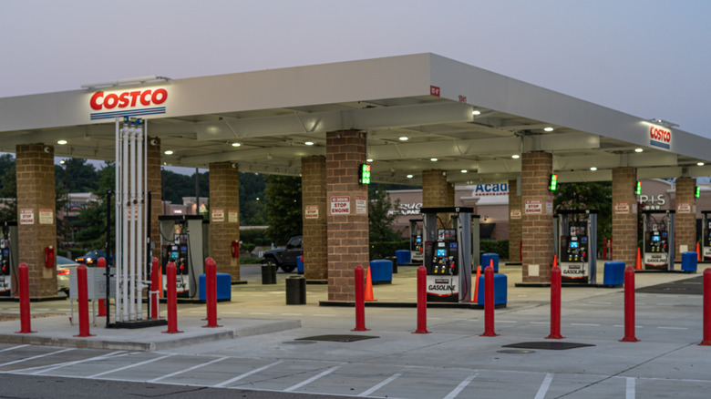 A large Costco gas station lit up at dusk