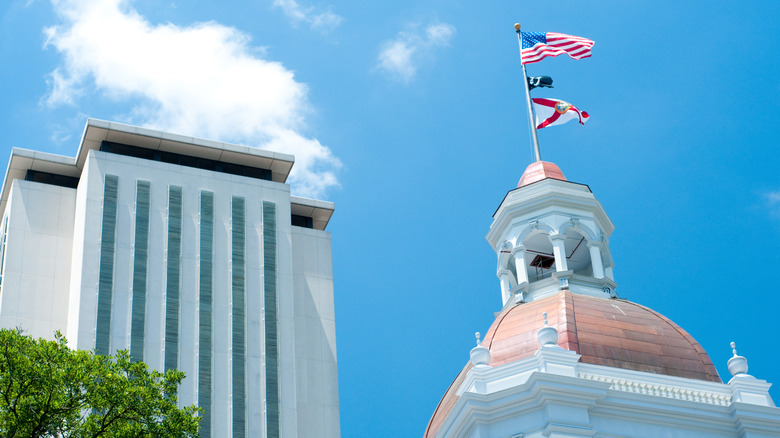 Top of Florida Capitol with flags flying