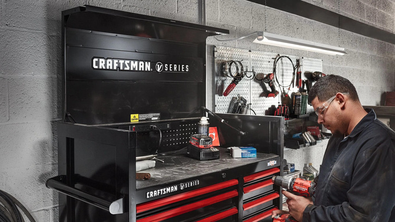 A worker next to a Craftsman V-Series tool chest