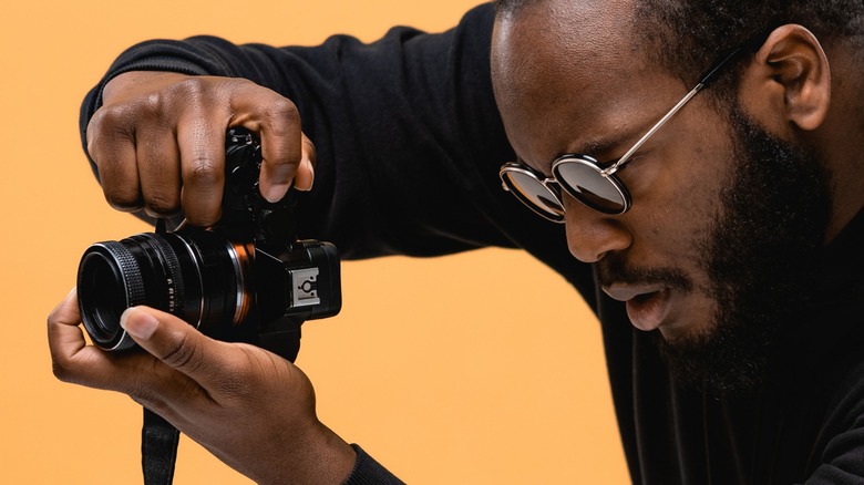 Professional photographer holding a full-frame camera