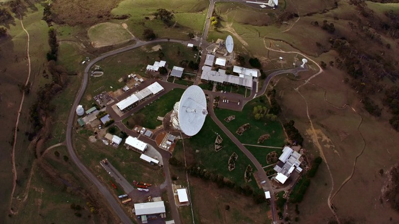 An aerial view of a facility with a large radio antenna