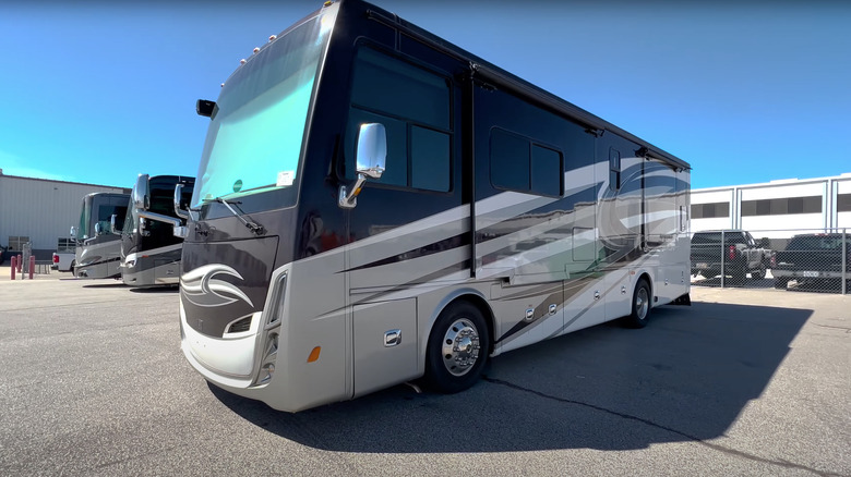 2017 Allegro Breeze parked on a paved surface with buildings and other vehicles in the background
