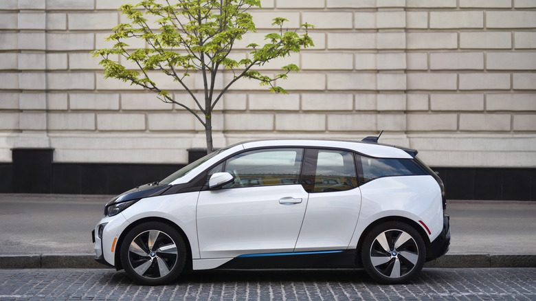 BMW i3 parked by tree