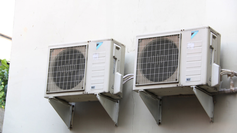 Two Daikin compressors installed on an external wall