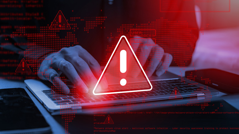 A person in black typing on a laptop with an illustration of red exclamation point icons overlayed indicating a warning