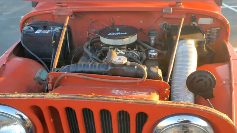 High-angle view of Dauntless V6 inside a red Jeep CJ5 engine bay