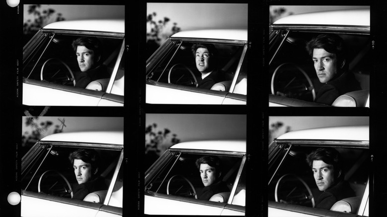 David Lynch sitting in the driver's seat of a car