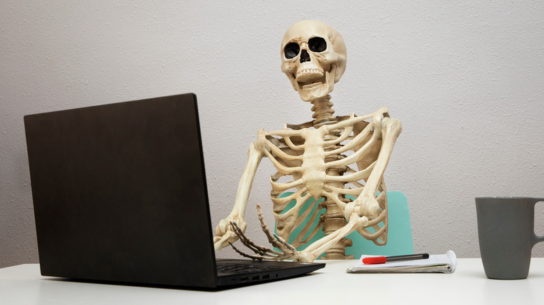 A skeleton at a desk