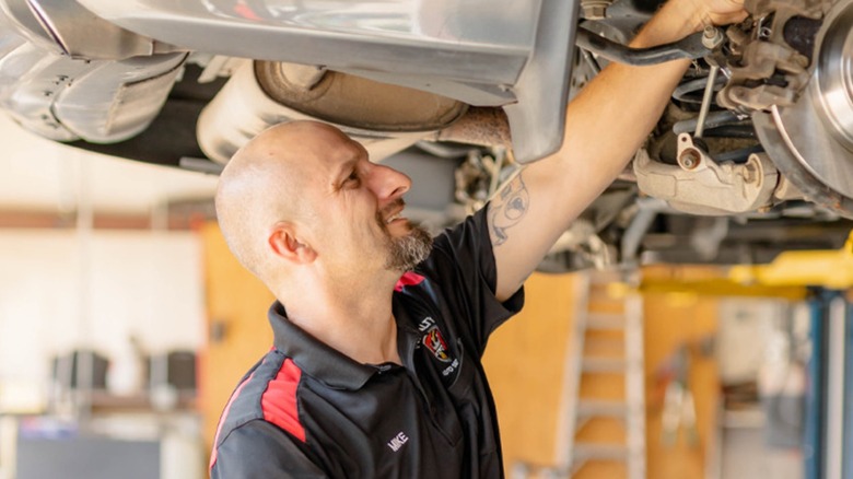 A Royalty Auto Service technician working on a car