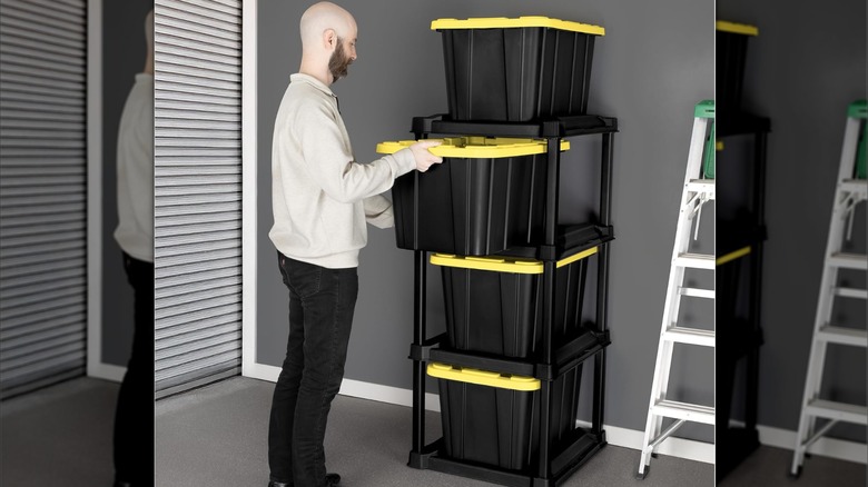 A man pulling a storage bin from a tote rack
