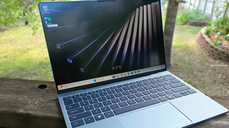 The Dell XPS 13 laptop opened to its home screen displaying the XPS logo