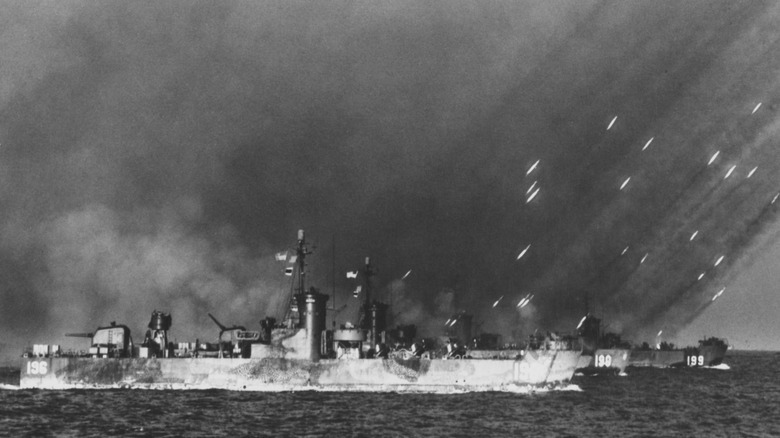 USS LSM(R)-190 (MacKay) fires a barrage of rockets in salvos on to the shores of Tokishi Shima