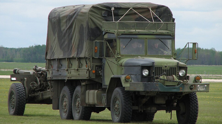 Military officials driving M35 truck