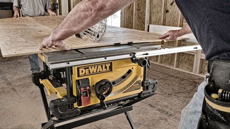 A person using a DeWalt table saw.
