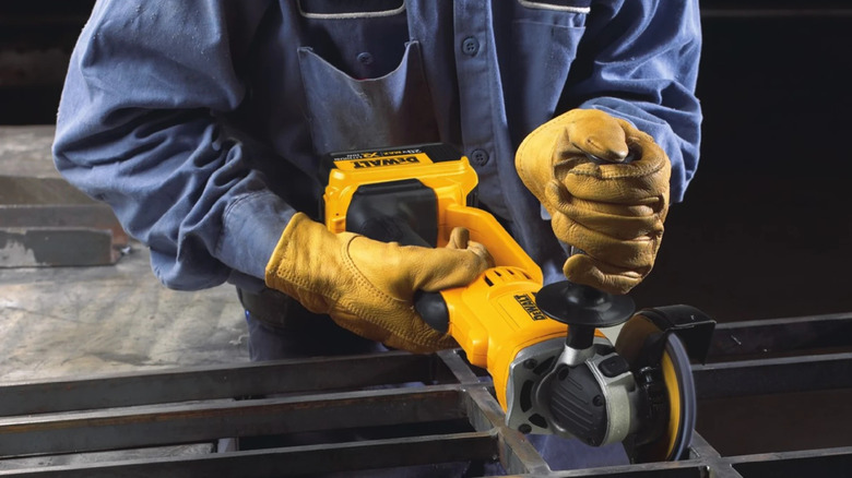 Worker using DeWalt Cut-Off Tool on metal structure