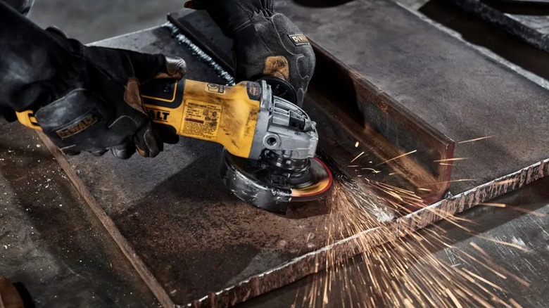 A person using a DeWalt Elite Series grinding wheel.