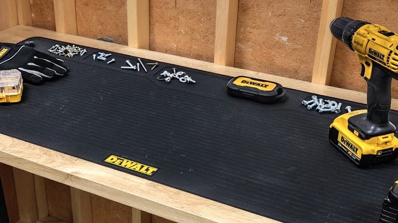 DeWalt workbench mat being used to hold power tools and other items