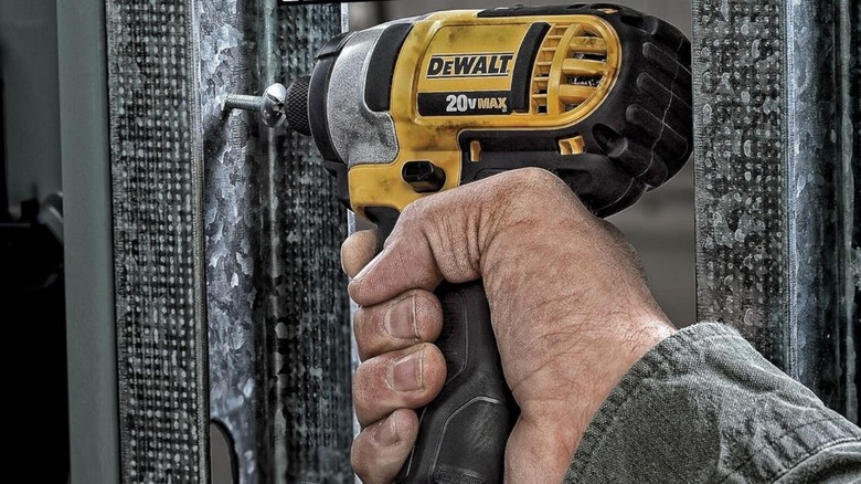 Person using DeWalt drill