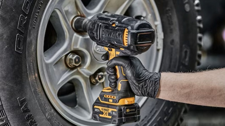 Removing lug nuts with a DeWalt DCF900 1/2-inch drive impact wrench.