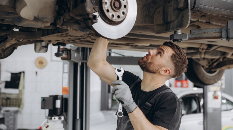 Mechanic working under vehicle