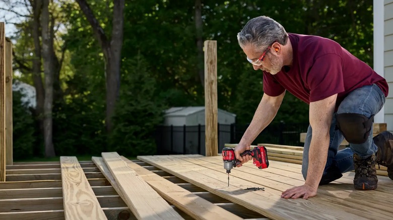 a person using a craftsman impact driver to build a deck