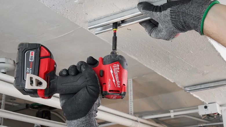 Milwaukee impact drill being used during construction