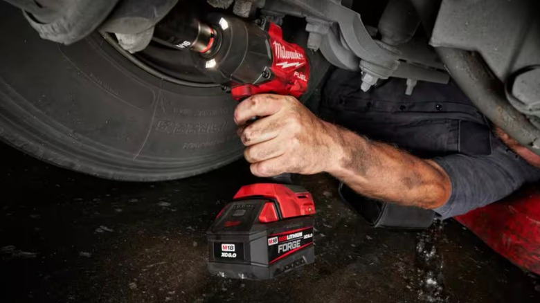 Milwaukee M18 Fuel Impact Wrench being used on undercarriage