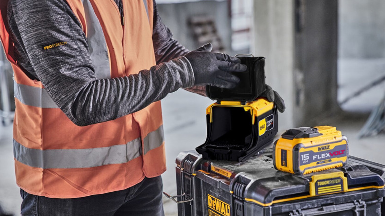 A worker setting up a DeWalt Flexvolt to Powershift adapter.