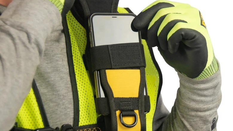 Person wearing DeWalt phone holder