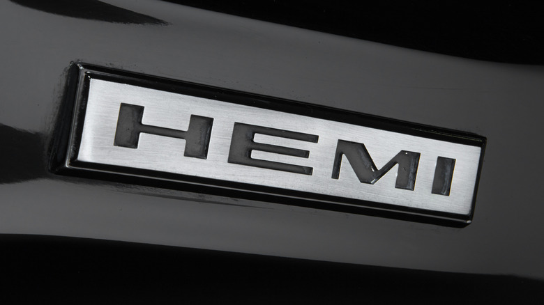 A close-up shot of a HEMI badge on a black 1968 Dodge Charger