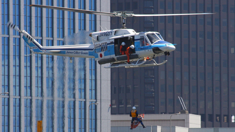 A Subaru Bell 412 helicopter in rescue mode in a city center.