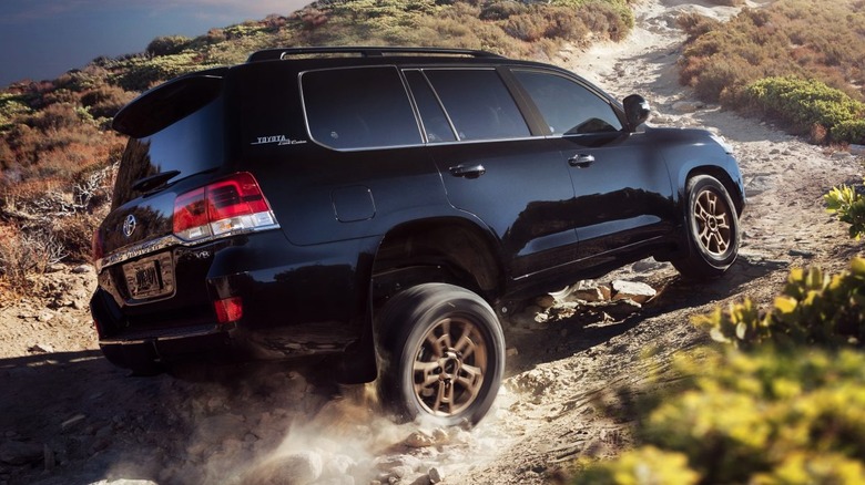 Black 2021 Toyota Land Cruiser on rocky trail.