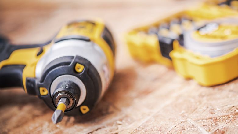 A DeWalt drill on a wood table