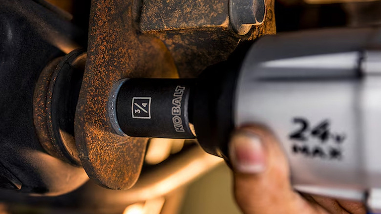 Person uses 10mm socket on car