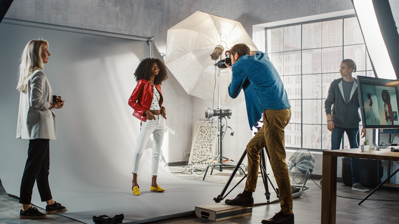 photographer taking portraigs in professional studio