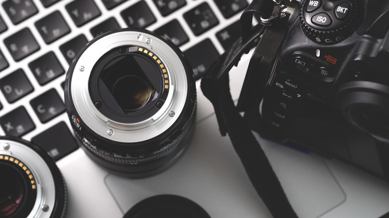 Canon lenses and camera with laptop
