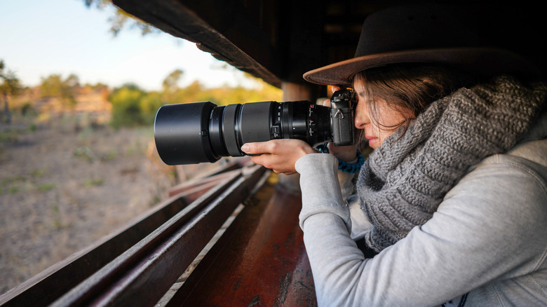 woman taking photo with telephoto zoom