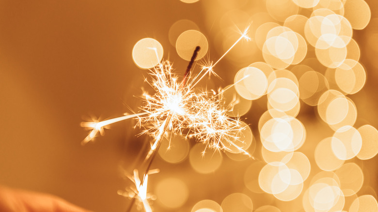 lit sparkler with bokeh effect
