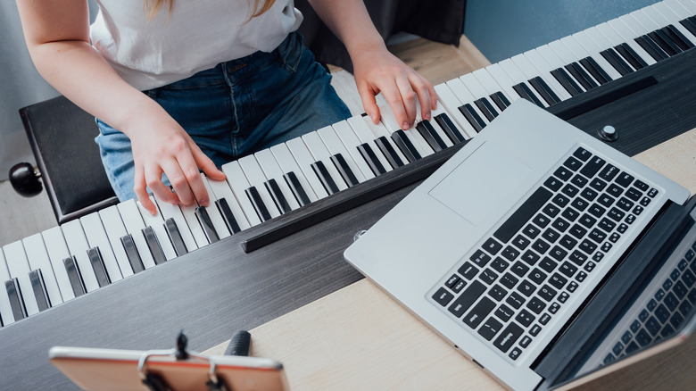 woman playing digital piano