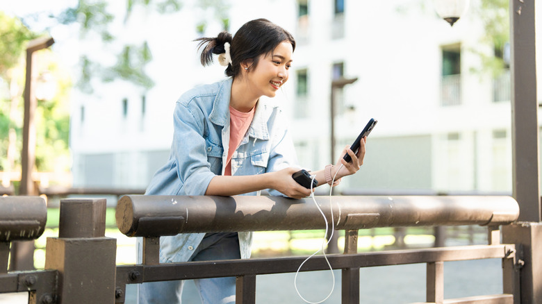 Girl using phone while charging