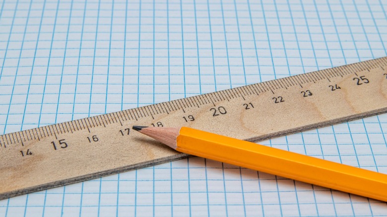 A pencil and ruler on a sheet of graph paper.