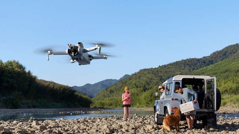 People flying a DJI Mini 3 drone.