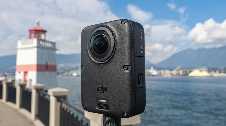 The DJI Osmo 360 ii by the ocean next to a lighthouse.