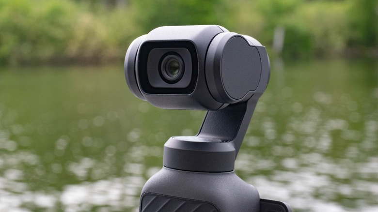 The camera of the DJI Osmo Pocket 4 with water in the background.