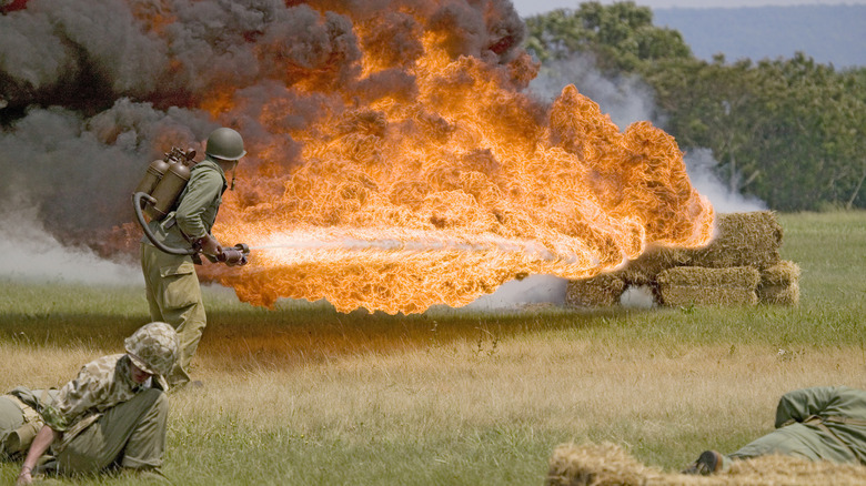 A WWII Reenactment Where A Soldier Uses A Flamethrower