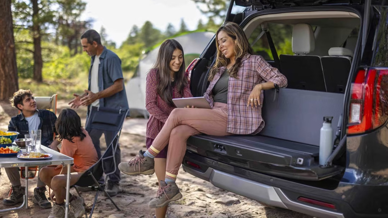 ford expedition split tailgate with people sitting on top