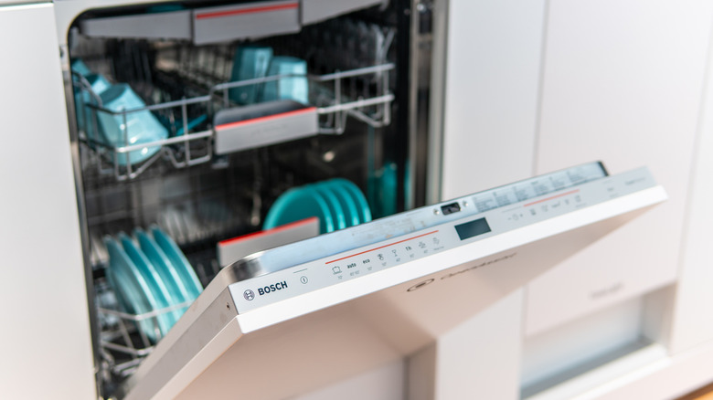 Bosch dishwasher open with full set of dishes inside