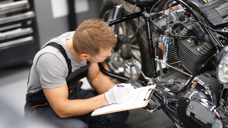 Man inspecting motorcycle components